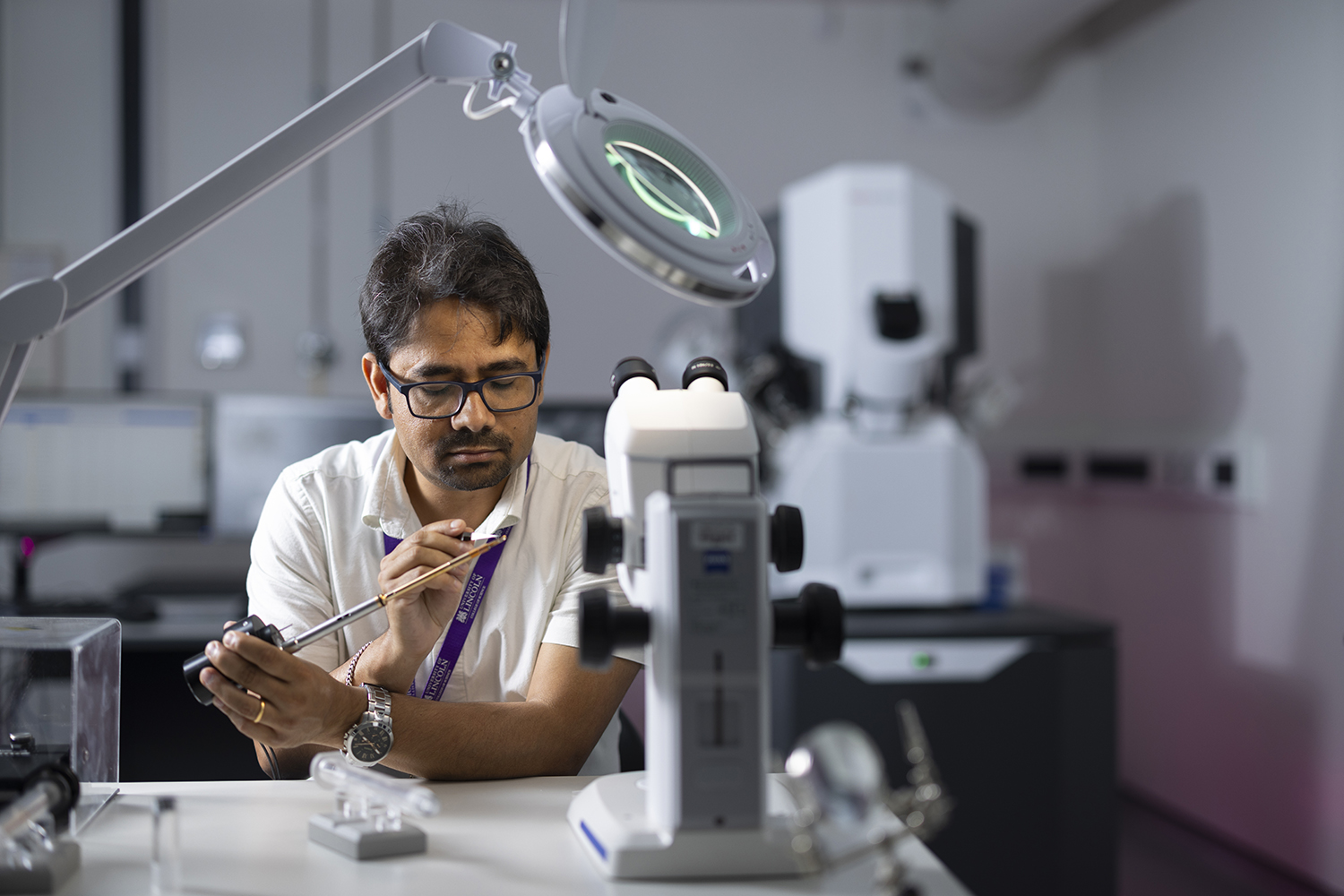 Man loading a TEM sample onto a sample holder