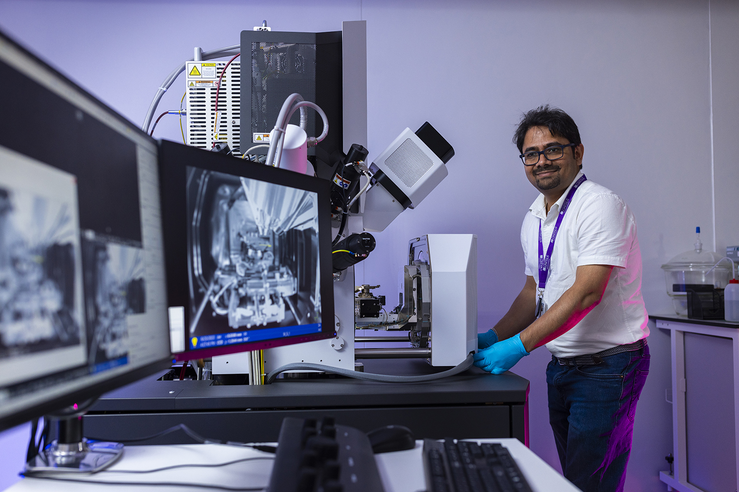 Man stood in front of a FIB-SEM